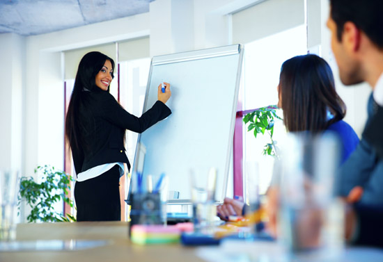 Businesswoman giving an SEO presentation to colleagues at workplace